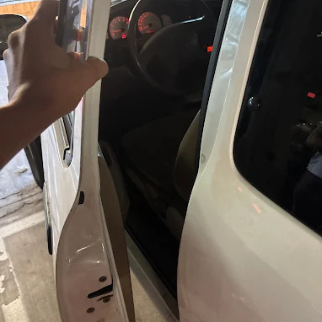 Technician unlocking a locked car door in the San Fernando Valley