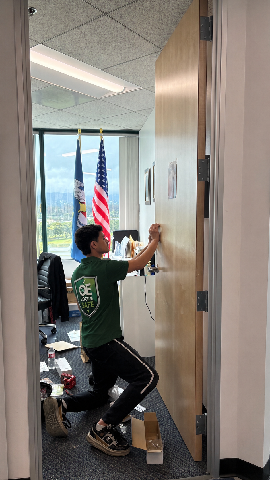 Technician servicing an office door during a commercial call