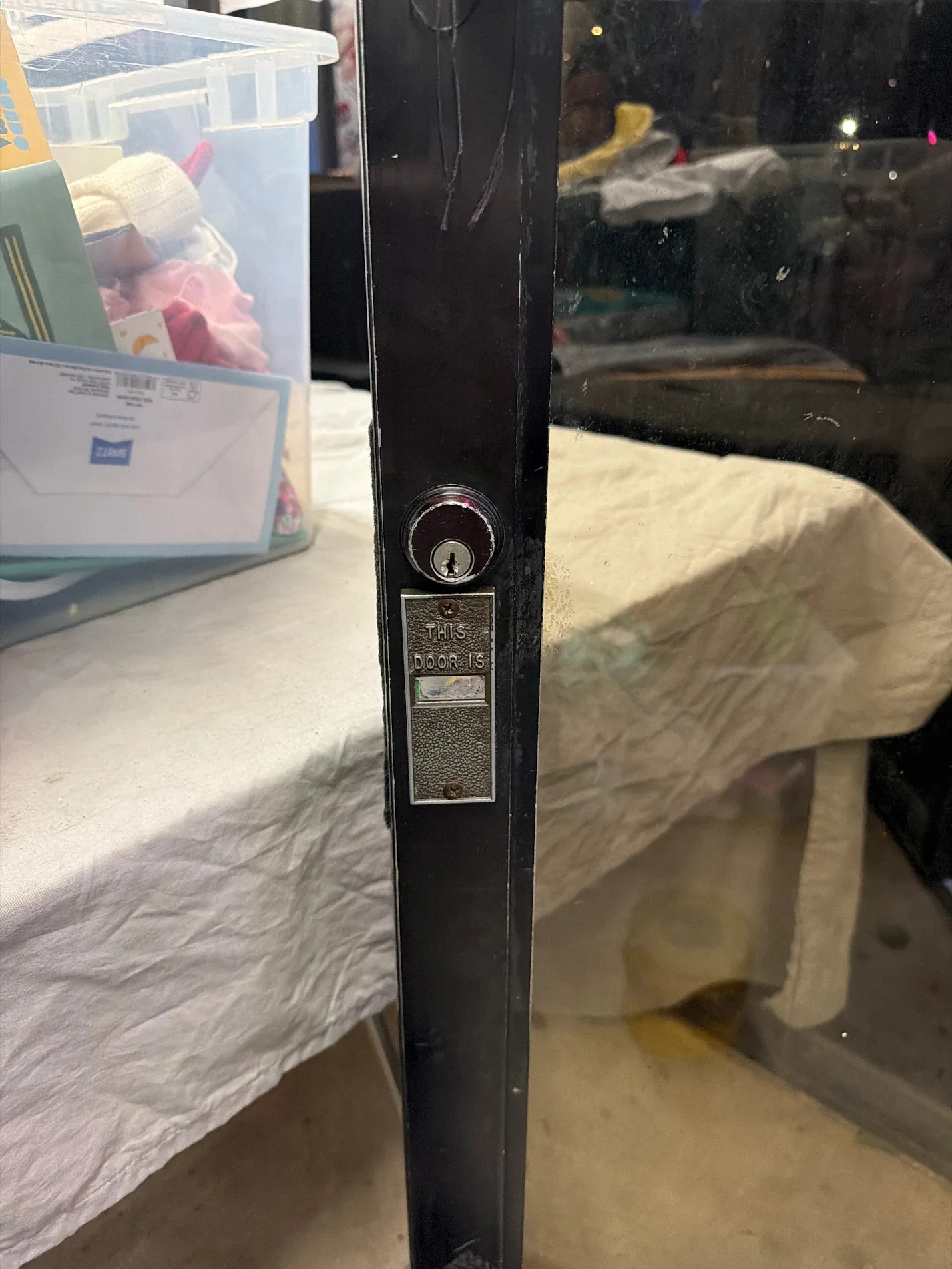 Close-up of a storefront lock before service