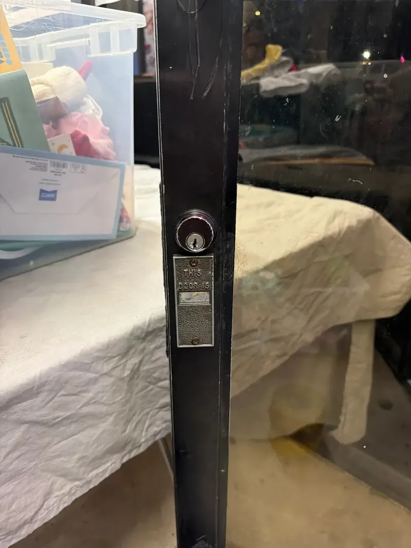 Close-up of a storefront lock before service