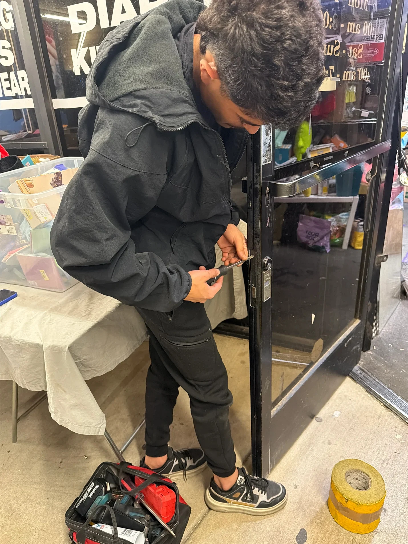 Technician opening a locked storefront door