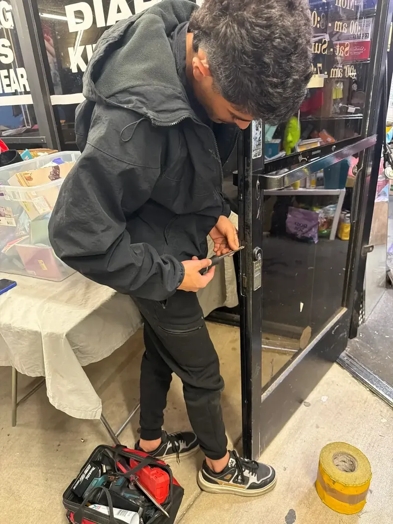 Technician opening a locked storefront door